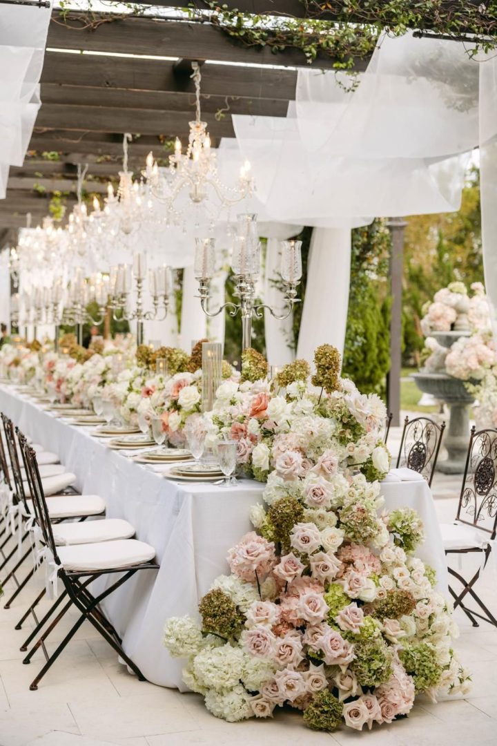 Wedding tablescape decorated with fresh flowers and elegant place settings.